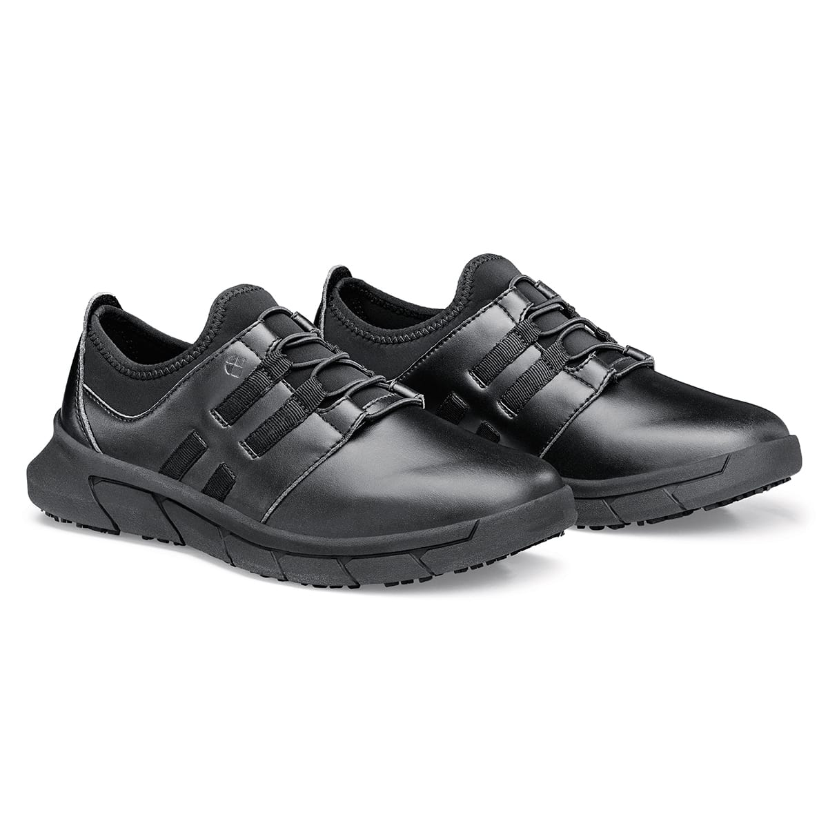 The Karina Black by Lila from Shoes For Crews are black slip-resistant trainers that are lightweight and have Flex Tread technology, pair seen in profile on the right.