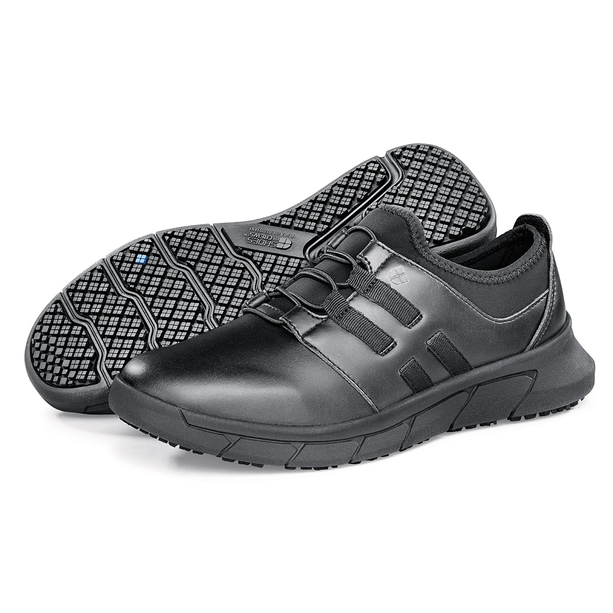 The Karina Black by Lila from Shoes For Crews are black slip-resistant trainers that are lightweight and have Flex Tread technology, pair seen from the left side and the sole.