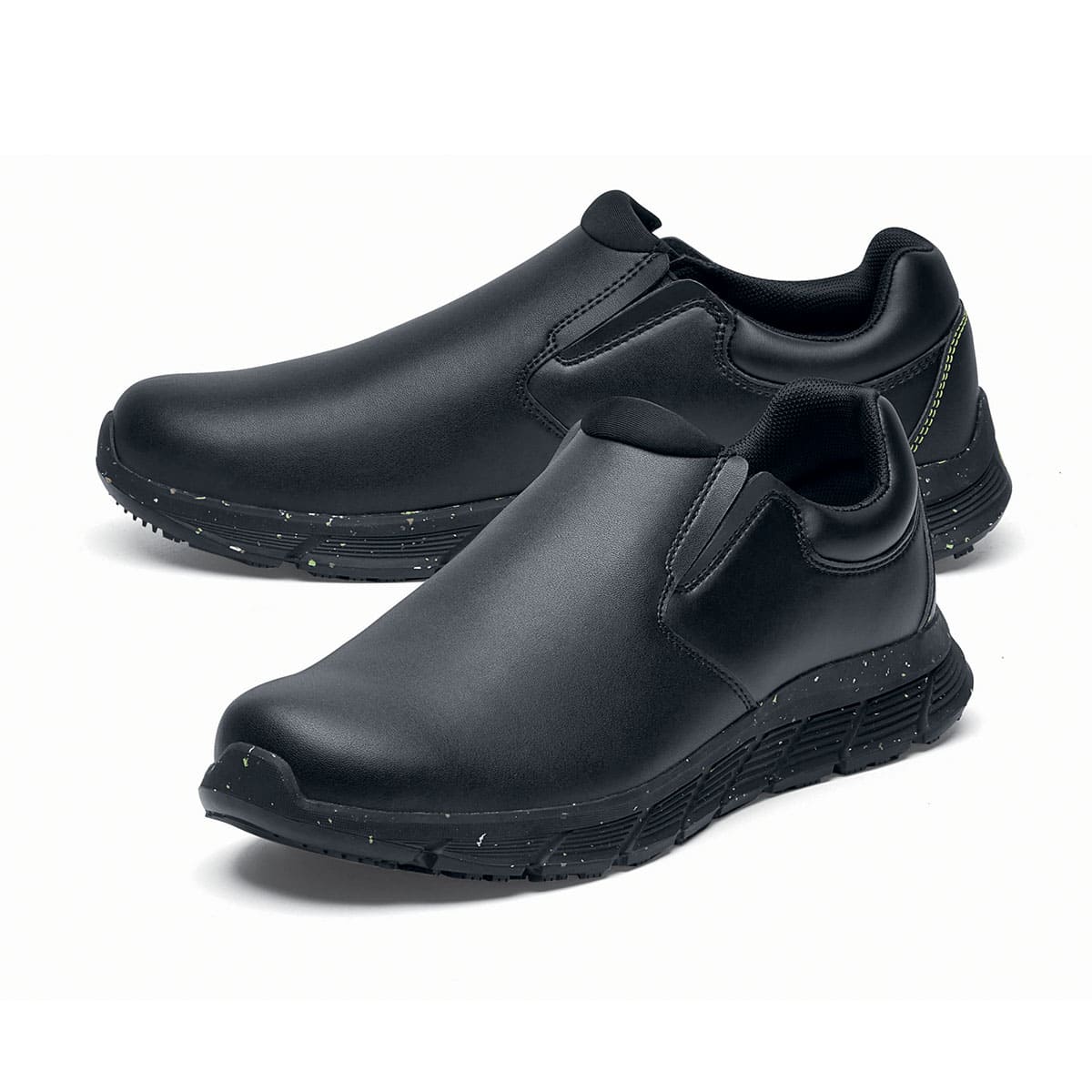 The Shoes for Crews Cater Eco Women's  Black is a sustainable, slip-resistant safety shoe, pair seen from the left  side, emphasised on the tip of the left shoe.