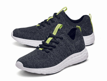 The Everlight™ ECO Womens Black/Grey from Shoes For Crews are lightweight, breathable slip-resistant trainers made from recycled materials,  pair seen from the left side, emphasised on the tip of the left  shoe.