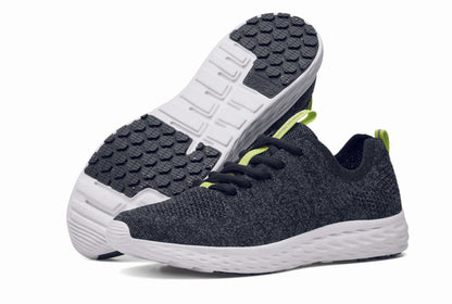 The Everlight™ ECO Womens Black/Grey from Shoes For Crews are lightweight, breathable slip-resistant trainers made from recycled materials,  pair seen from the left side and the sole.
