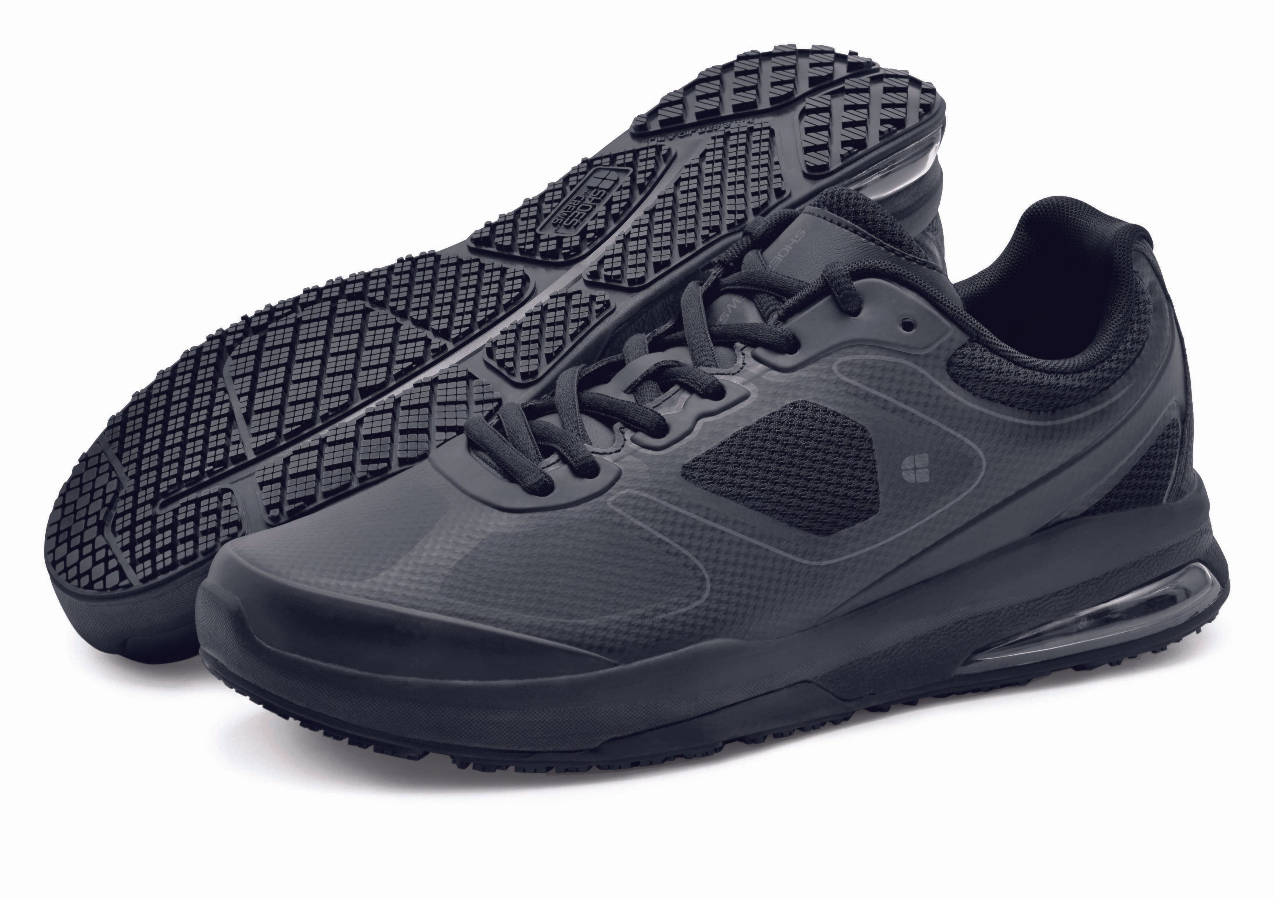 The Revolution II Black from Shoes For Crews are slip-resistant trainers designed to provide comfort, pair seen from the left side and the sole.