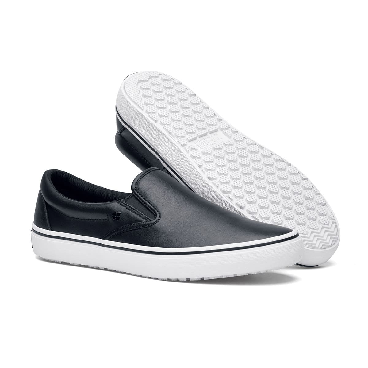 The Merlin Slip On Black and White from Shoes For Crews are slip-on trainers that are slip-resistant, lightweight, easy to clean and water-resistant, pair seen from the right side and the sole.