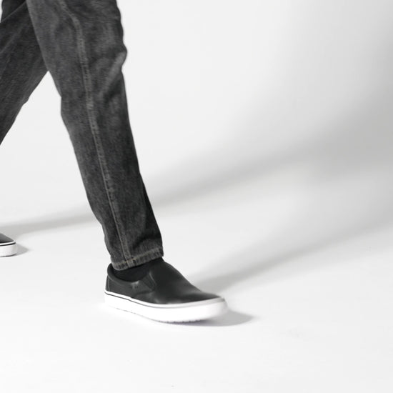 The Merlin Slip On Black and White from Shoes For Crews are slip-on trainers that are slip-resistant, lightweight, easy to clean and water-resistant, product video.